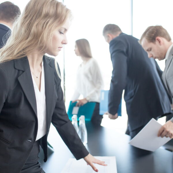 Business people coming and sitting at meeting table