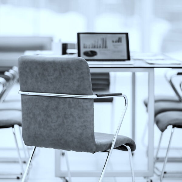 open laptop computer with financial charts on the table with the Manager in a modern office. the photo is a blank space for your text